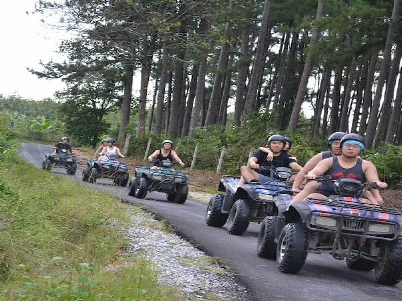 Tourists riding ATV in a straight line formation at ATV Adventure Ride Langkawi